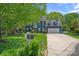 Beautiful two-story home with manicured lawn, lush landscaping, and a two-car garage at 8651 Walsham Dr, Charlotte, NC 28277