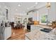 Spacious kitchen featuring granite countertops, stainless steel appliances, white cabinets, and hardwood floors at 8651 Walsham Dr, Charlotte, NC 28277