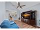 Comfortable living room with a large TV, ceiling fan, and open layout to a modern kitchen and dining area at 8651 Walsham Dr, Charlotte, NC 28277