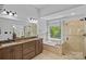 Luxurious main bathroom with double vanity, granite countertops, bathtub, and glass-enclosed shower at 8651 Walsham Dr, Charlotte, NC 28277