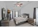 Comfortable bedroom featuring a large bed, coordinating furniture, neutral color scheme, and a ceiling fan at 8651 Walsham Dr, Charlotte, NC 28277