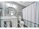 Charming bathroom with a vanity, round mirror, and a shower/tub combo with a curtain at 901 Heritage Pkwy, Fort Mill, SC 29715