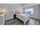 Cozy bedroom with neutral tones, wood-look flooring, a ceiling fan, and ample natural light at 901 Heritage Pkwy, Fort Mill, SC 29715