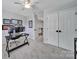 Neutral bedroom featuring a ceiling fan, carpeted floors, two white closets, and an office workstation at 901 Heritage Pkwy, Fort Mill, SC 29715