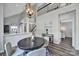 Bright dining area with round table, views of kitchen and upstairs, modern chandelier, and stylish decor at 901 Heritage Pkwy, Fort Mill, SC 29715