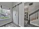 Open hallway with barn door, window, laundry room and staircase, and vinyl floors offer style and functionality at 901 Heritage Pkwy, Fort Mill, SC 29715