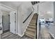 Bright hallway featuring wood-look flooring, stairs to the upper level, and an open doorway to a living space at 901 Heritage Pkwy, Fort Mill, SC 29715