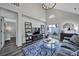 Bright living room featuring vaulted ceilings, a modern chandelier, and access to the outdoor patio at 901 Heritage Pkwy, Fort Mill, SC 29715
