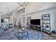 Open-concept living space with modern furnishings, high ceilings, and a view of the staircase at 901 Heritage Pkwy, Fort Mill, SC 29715