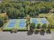 Aerial view of community tennis courts on sunny day surrounded by trees, parking lot and green space at 901 Heritage Pkwy, Fort Mill, SC 29715