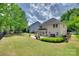 Backyard featuring a concrete patio with furnishings, and fenced in yard with lush landscaping at 985 Angelica Ln, Tega Cay, SC 29708