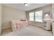 Charming bedroom featuring a daybed with a soft, pink comforter and bright natural light at 985 Angelica Ln, Tega Cay, SC 29708