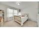 Bright bedroom featuring a bed with white comforter and a large window with white curtains at 985 Angelica Ln, Tega Cay, SC 29708