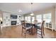 Dining area with cozy fireplace, hardwood floors, and seamless connection to the living space at 985 Angelica Ln, Tega Cay, SC 29708