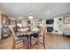 Open-concept dining area with fireplace, wood floors, and seamless connection to kitchen at 985 Angelica Ln, Tega Cay, SC 29708