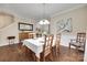Bright dining room featuring wainscoting, hardwood floors, and modern lighting at 985 Angelica Ln, Tega Cay, SC 29708