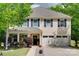 Charming two-story home featuring a manicured lawn and three-car garage at 985 Angelica Ln, Tega Cay, SC 29708