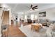 Open concept living room with hardwood floors, dining area, and staircase at 985 Angelica Ln, Tega Cay, SC 29708