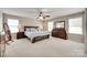 Large main bedroom with a ceiling fan, windows, and plenty of space for relaxation at 985 Angelica Ln, Tega Cay, SC 29708