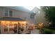 Backyard with concrete patio, outdoor furniture, string lights, and landscaping at dusk at 985 Angelica Ln, Tega Cay, SC 29708