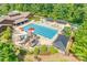 Aerial view of community pool with waterslide, splash pad, lounge chairs, and covered seating areas at 985 Angelica Ln, Tega Cay, SC 29708