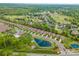 Expansive aerial view of the neighborhood showcasing the community pool, pond, and lush surroundings at 1008 Avalon Pl, Matthews, NC 28104