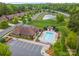Birds-eye view of the community pool, clubhouse, pond, and manicured landscaping at 1008 Avalon Pl, Matthews, NC 28104