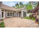 Spacious back patio with a screened-in porch, and lush landscaping, perfect for outdoor enjoyment at 1008 Avalon Pl, Matthews, NC 28104