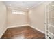 Neutral bedroom with hardwood floors, white trim, and a window for natural light at 1008 Avalon Pl, Matthews, NC 28104