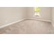 Bedroom with neutral carpet, white trim, a window and ample space at 1008 Avalon Pl, Matthews, NC 28104