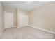 Spacious bedroom with neutral carpet, ceiling fan, and closet for convenient storage at 1008 Avalon Pl, Matthews, NC 28104