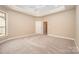 Bedroom with neutral carpet, white ceiling fan and trim, and a standard door at 1008 Avalon Pl, Matthews, NC 28104
