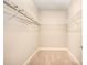 Spacious walk-in closet with carpet, built-in shelves for easy organization and storage at 1008 Avalon Pl, Matthews, NC 28104