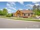 Beautifully landscaped clubhouse featuring stone accents, timber details, and well-manicured landscaping at 1008 Avalon Pl, Matthews, NC 28104