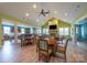 Spacious common area with a dining table, chairs, fireplace, and ample seating for community gatherings at 1008 Avalon Pl, Matthews, NC 28104