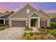 Attractive home featuring stone and siding details, a two-car garage, and lovely front yard landscaping at 1008 Avalon Pl, Matthews, NC 28104