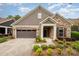 Beautiful home featuring a stone and siding exterior, a two-car garage, and a professionally landscaped front yard at 1008 Avalon Pl, Matthews, NC 28104