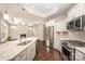Elegant kitchen boasts stainless steel appliances, island sink, and opens to living space at 1008 Avalon Pl, Matthews, NC 28104