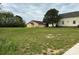 Large grassy backyard with an adjacent residential building, perfect for outdoor activities at 103 E Main St, Dallas, NC 28034