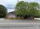 Commercial building available for sale with two shade trees and an inviting facade at 103 E Main St, Dallas, NC 28034
