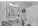Clean bathroom features a sink, vanity, and large mirror, offering a functional and tidy space at 1052 Harlow'S Crossing Dr, Weddington, NC 28104