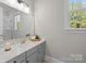 Bright bathroom with quartz counters, light gray cabinetry, modern fixtures, and natural light at 1052 Harlow'S Crossing Dr, Weddington, NC 28104