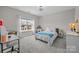 Bright bedroom featuring a comfortable bed and desk area, providing a peaceful space for rest and productivity at 1052 Harlow'S Crossing Dr, Weddington, NC 28104