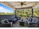 Inviting covered deck with a ceiling fan and comfortable seating, perfect for outdoor relaxation at 1052 Harlow'S Crossing Dr, Weddington, NC 28104