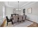 Formal dining room featuring elegant wainscoting, a modern chandelier, and ample seating at 1052 Harlow'S Crossing Dr, Weddington, NC 28104