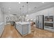 Modern kitchen features a central island with seating, stainless steel appliances, and ample cabinet space for storage at 1052 Harlow'S Crossing Dr, Weddington, NC 28104
