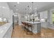 Spacious kitchen featuring a large island with seating, pendant lighting, and modern appliances, perfect for entertaining at 1052 Harlow'S Crossing Dr, Weddington, NC 28104