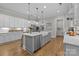 Open-concept kitchen with a large island, stainless steel appliances, and custom cabinetry offers functionality and style at 1052 Harlow'S Crossing Dr, Weddington, NC 28104