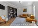 Comfortable living room with hardwood floors, a sectional sofa, and a large bookshelf at 1052 Harlow'S Crossing Dr, Weddington, NC 28104