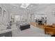 Open-concept living room with hardwood floors, coffered ceilings, and seamless flow to the kitchen at 1052 Harlow'S Crossing Dr, Weddington, NC 28104